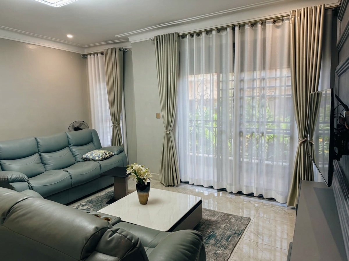 Bright furnished living room with floor-to-ceiling curtains
